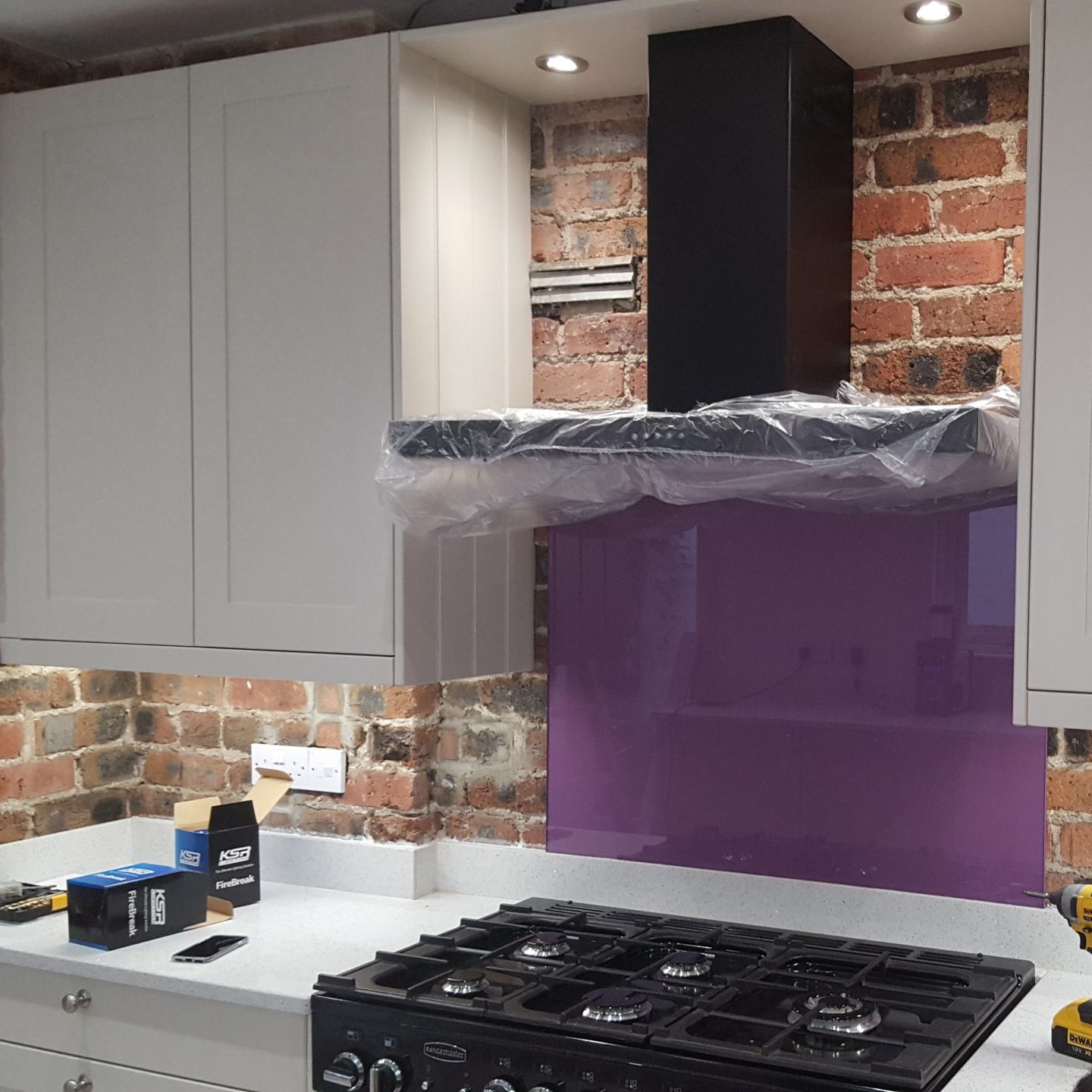 Kitchen with electrical appliance, brick walls for back splash